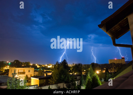 Multiple lightning bolts layer the sky at night over a desert mountain ...
