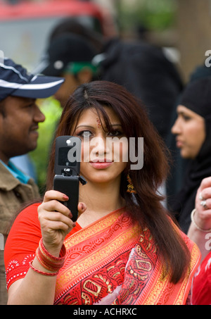 Young asian woman waring a traditional saree using her camera phone Stock Photo