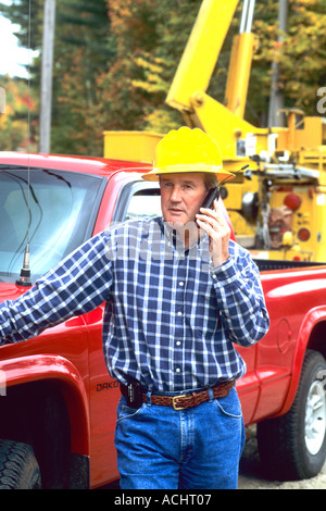 Construction worker talking on portable phone on job site Stock Photo