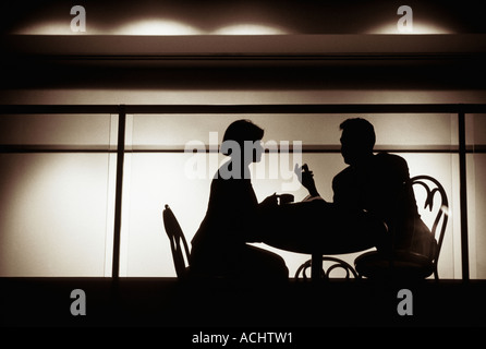 Couple talking in intimate nightclub setting Stock Photo