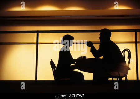 Couple talking in intimate nightclub setting Stock Photo