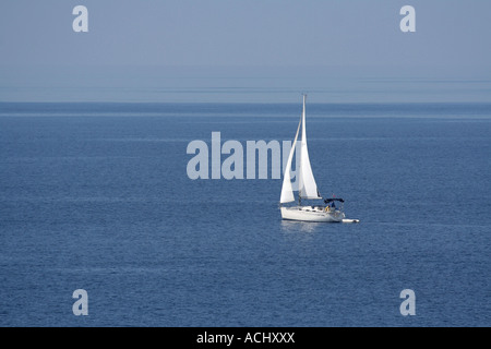 Solitary sailing yacht on the blue Mediterranean sea Stock Photo