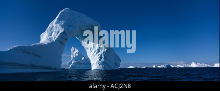 Antarctica Boothe Island Afternoon sun lights iceberg arch near Port Charcot southwest of Lemaire Channel Stock Photo