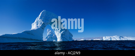 Antarctica Boothe Island Afternoon sun lights iceberg arch near Port Charcot southwest of Lemaire Channel Stock Photo