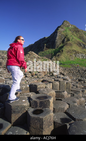 Person on the hexagonal columns of the Giant's Causeway, Co Antrim, Northern Ireland. Stock Photo