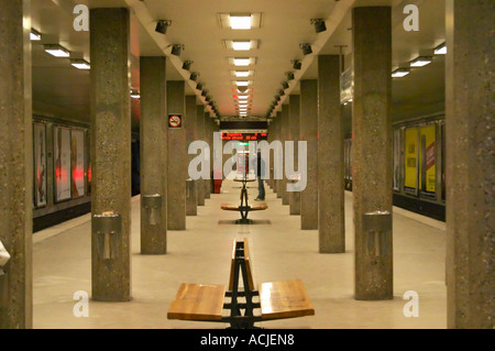 The Stockholm underground subway Tunnelbanan Tunnelbana an empty platform at the station Radmansgatan with a man standing in the distance and concrete pillars publicity posters on the walls Stockholm, Sweden, Sverige, Europe Stock Photo
