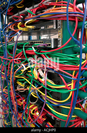 Mass of coloured network wiring - 10BaseT Category 5 network wiring in red green blue and yellow Stock Photo