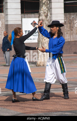 Plaza de Cagancha Square, a couple man and woman dancing flamenco and tango on a city square, dressed in blue skirt black top, white pants, blue shirt and black hat Montevideo, Uruguay, South America Stock Photo
