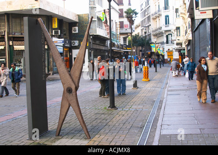 A sculpture of perhaps a pair of scissors by the Uruguay artist Joaquin Torres Garcia outside the entrance to the museum for his work in the city on the pedestrian street Sarandi near Plaza Independencia Independence Square with many people walking. Montevideo, Uruguay, South America Stock Photo