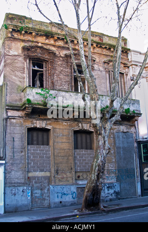 An old run down ruin of a town house building in the city, doors and windows shut with bricks and mortar. Montevideo, Uruguay, South America Stock Photo