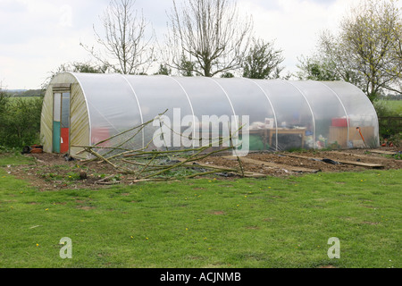 A large poly tunnel in a vegetable garden, Hampshire England. Stock Photo