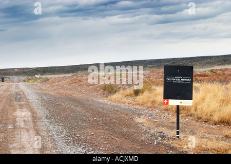 Very end of the world long straight dirt road across the Patagonian desert with a sign to the bodega del fin del Mundo Bodega Del Fin Del Mundo – The End of the World - Neuquen, Patagonia, Argentina, South America Stock Photo