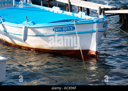 Typical Provencal fishing boats painted in bright colours white, blue, green red yellow, moored at a jetty Le Brusc Six Fours Var Cote d’Azur France Stock Photo