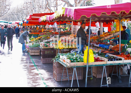 Street market merchant's stall with fruits and vegetables in rain Sanary Var Cote d’Azur France Stock Photo