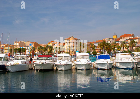 The harbour with boats and buildings along the water in Bandol. White motor yachts Bandol Cote d’Azur Var France Stock Photo