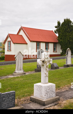 The Kauri Museum original pioneer church 1867 grave yard with ornate old stone cross headstone Matakohe Northland North Island Stock Photo