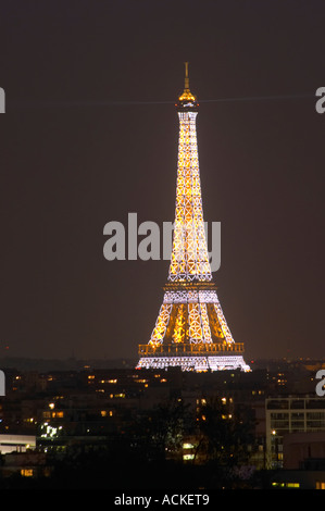 The Eiffel Tower in Paris illuminated at night against a dark blue black sky glittering special effects white blinking light making a pattern Paris France Stock Photo