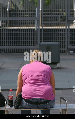 A woman sits on a seat, Glasgow, Scotland. Stock Photo