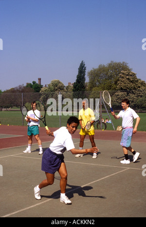 A tennis lesson for adults, Clissold Park, London, UK. Stock Photo