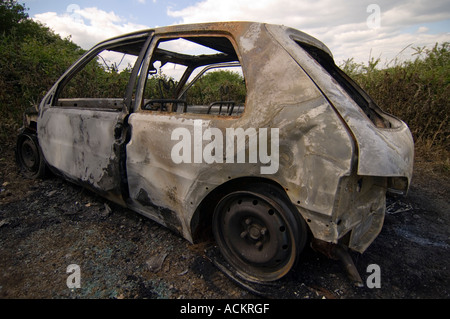 Burnt out car abandoned by car thieves in the UK Stock Photo