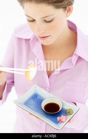 Young woman eating sushi Stock Photo