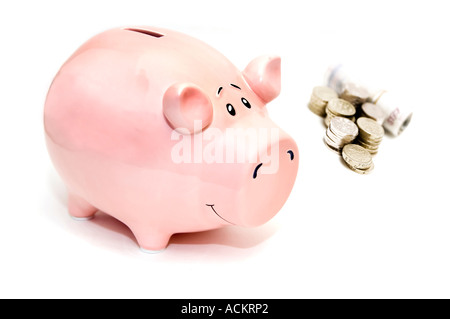 Chilrens pink piggybank with coins and notes Stock Photo