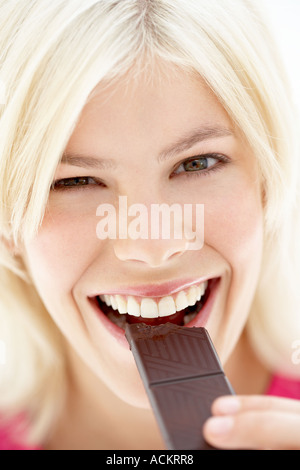 A young woman eating chocolate Stock Photo