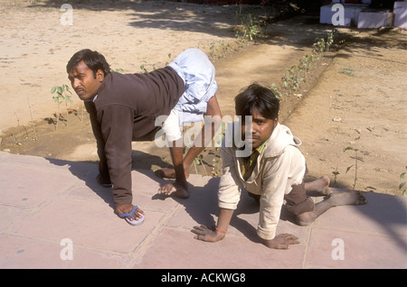 Two young men who have been crippled by polio Agra Uttar Pradesh India Stock Photo