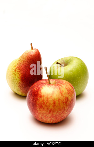 A pear with green and red apples arranged on a white background Stock Photo