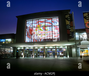 The main entrance to Graz railway station, Austria, at night, showing the interior mural by Peter Kogler. Stock Photo