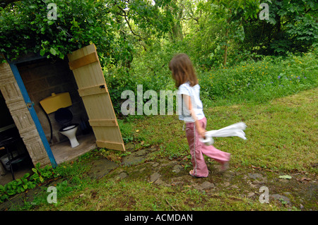 Toilet, Outside toilet, girl using an outdoor toilet Stock Photo