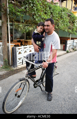 Turkish father and son on bicycle on way home from school in small village in Turkey. Stock Photo