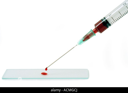 Syringe placing a blood sample on a slide. Stock Photo