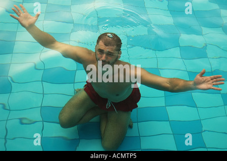 Man under the water in the pool Stock Photo