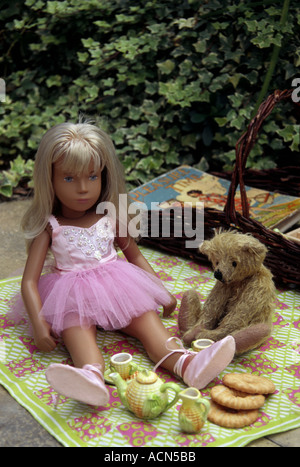 A Sasha doll and a toy bear having a teddy bears picnic Stock Photo
