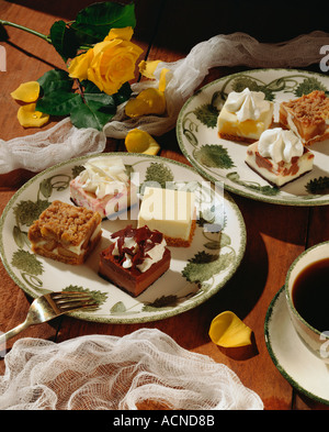 Petite squares of dutch apple chocolate strawberry and lemon cheesecake served with coffee Stock Photo