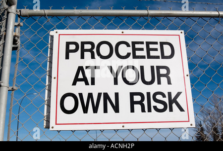 Proceed At Your Own Risk sign Stock Photo - Alamy