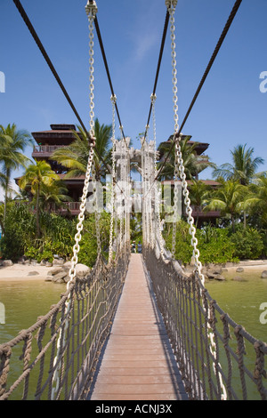 Wooden rope suspension bridge from Palawan beach across lagoon to southern most point of Asia 'Sentosa Island' Singapore Stock Photo