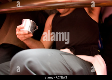 A float bearer drinking water during a stop in Holy Week processions, Seville, Spain 2006 Stock Photo