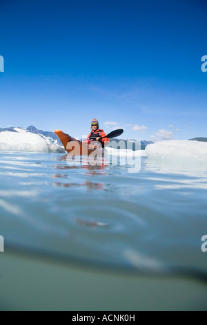 Female kayaker in Bear Cove Lagoon Resurrection Bay Alaska Kenai Fjords NP Kenai Peninsula summer Stock Photo