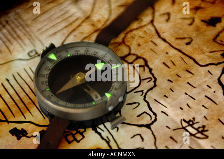 Vintage magnetic compass with green phosphorus pointer on a map Travel tourism still life Stock Photo