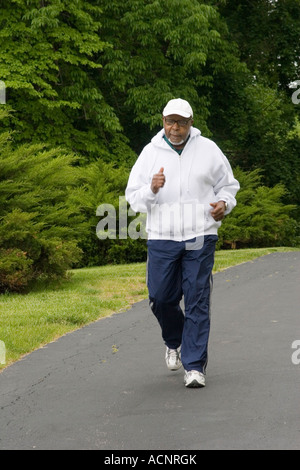 Elderly retired black African American man in his 70s walking briskly in relay walking race Stock Photo
