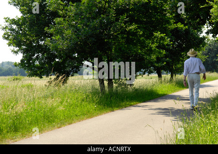 man dressed in white gent gentleman middle aged retired old walk walker stroll stroller rural countryside pleasant idyllic rest Stock Photo