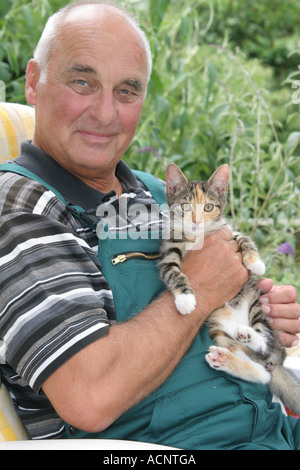 Old man with young Cat - Älterer Mann mit junger Katze Stock Photo