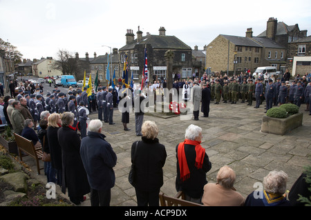 Crowd (men, women, members of uniformed organisations) gathered by cross - Remembrance Day service wreath laying, Guiseley, West Yorkshire, England UK Stock Photo