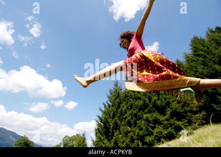 Young woman jumping, side view Stock Photo