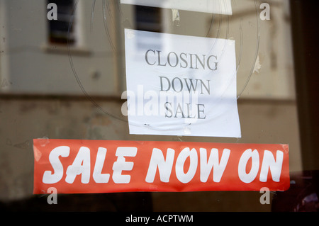 closing down sale sign in a shop window and red sale now on banner Stock Photo