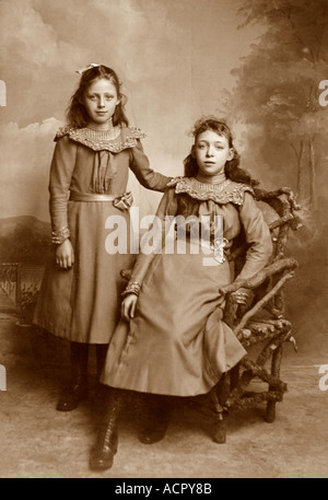 Original cabinet card photograph portrait of two pretty young Victorian or Edwardian era girls, probably sisters - circa 1899 Salisbury, Wiltshire, UK Stock Photo