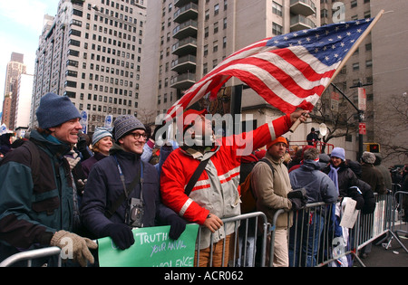 Man holding up American Flag during massive anti war rally in New York City Stock Photo