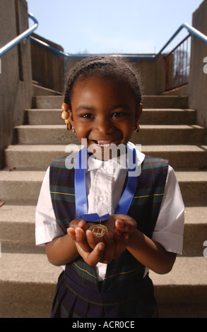 Small girl student with prize for national poetry contest Stock Photo